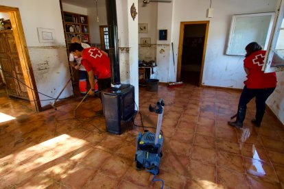 Dos voluntarios de la Creu Roja haciendo labores de limpieza tras el paso de la dana Alice por las Terres de l'Ebre.