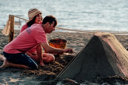 Sergi Ramirez i Montserrat Cuesta iniciant l’estructura d’una escultura a la platja.