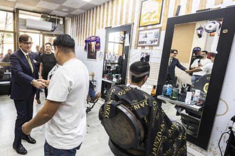 El President de la Generalitat, Salvador Illa, saludando a uno de los peluqueros. Rachid sonríe al fondo.