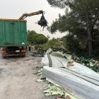Un camión recoge la mercancía en el arcén de la autopista a raíz de un accidente.