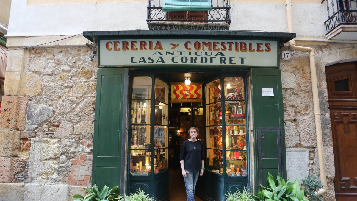 1. Xavier Pagès pintando a mano un cirio de Santa Tecla, un claro ejemplo de la diferenciación en la venta de productos que ofrece esta tienda.