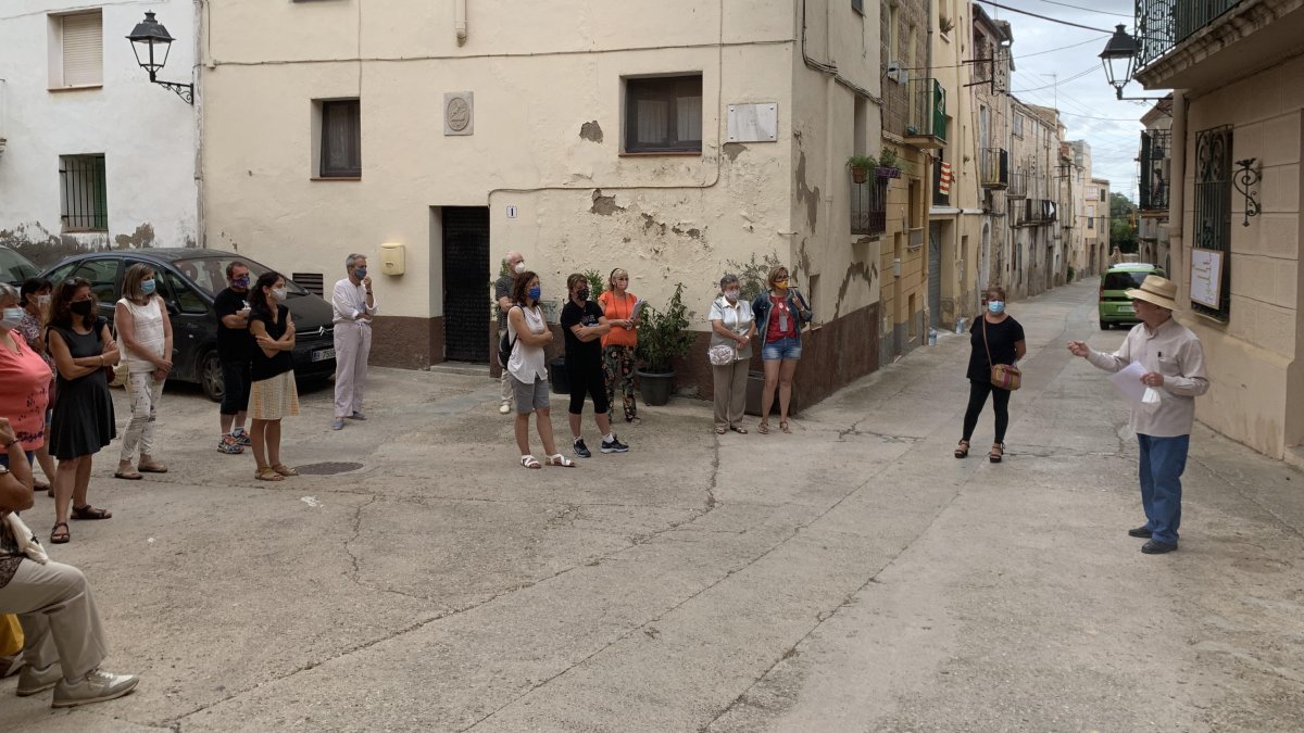 En Jordi Juncosa, veí de Cabra del Camp, a la dreta de la imatge, fent les explicacions davant de la casa del doctor Joan Giné i Partagàs, ubicada al carrer Major del poble.