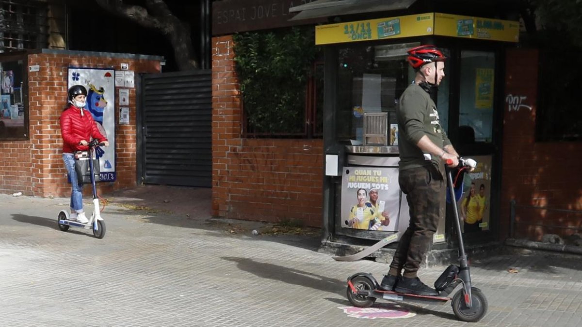 Imagen de archivo de un usuario circulando con patinete eléctrico y con casco por la acera de la Imperial Tarraco.