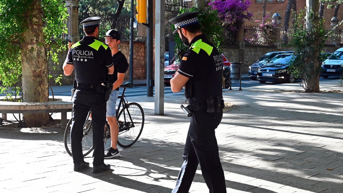 Agentes de la Guàrdia Urbana informando a un ciclista sobre la campaña, esta semana en el paseo Sunyer.