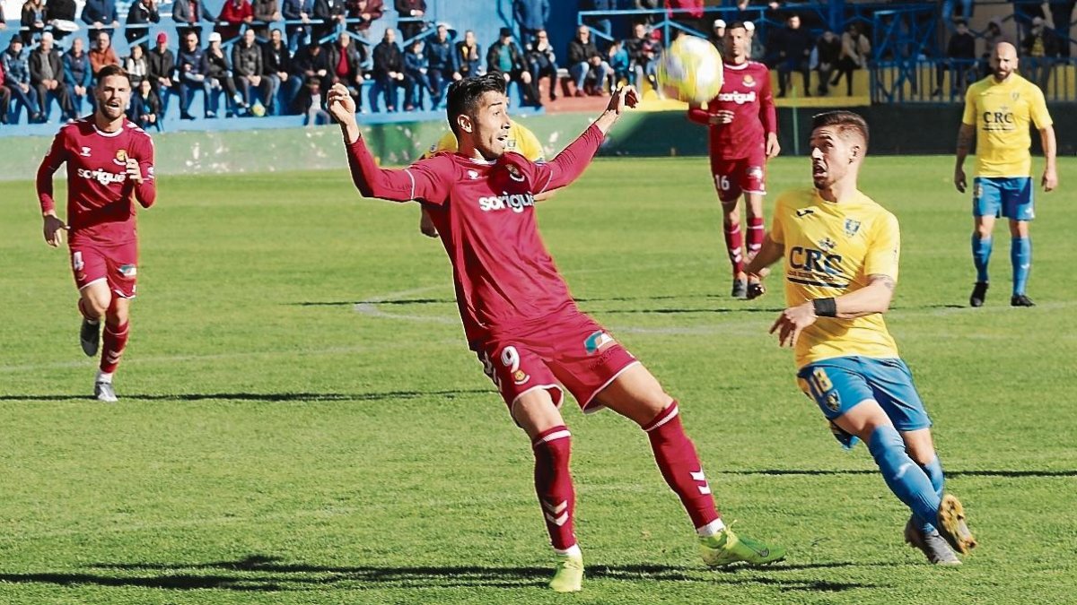 Gerard Oliva pelea por un balón dividio con un jugador del Orihuela.
