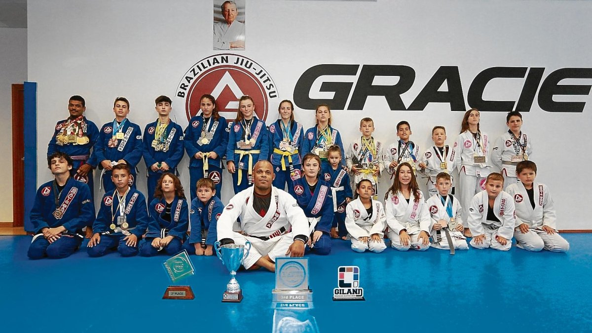 Los niños del Gracie Barra Vila-seca con sus medallas junto a su entrenador, el campeón del mundo Cristiano Ribas.