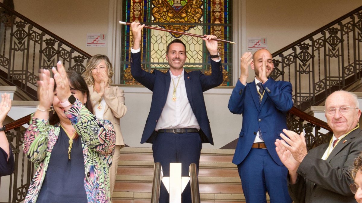 Jordi Jordan alça la vara d’alcalde envoltat del seu equip a les escales principals de l’ajuntament de Tortosa, en sortir del ple d’investidura.
