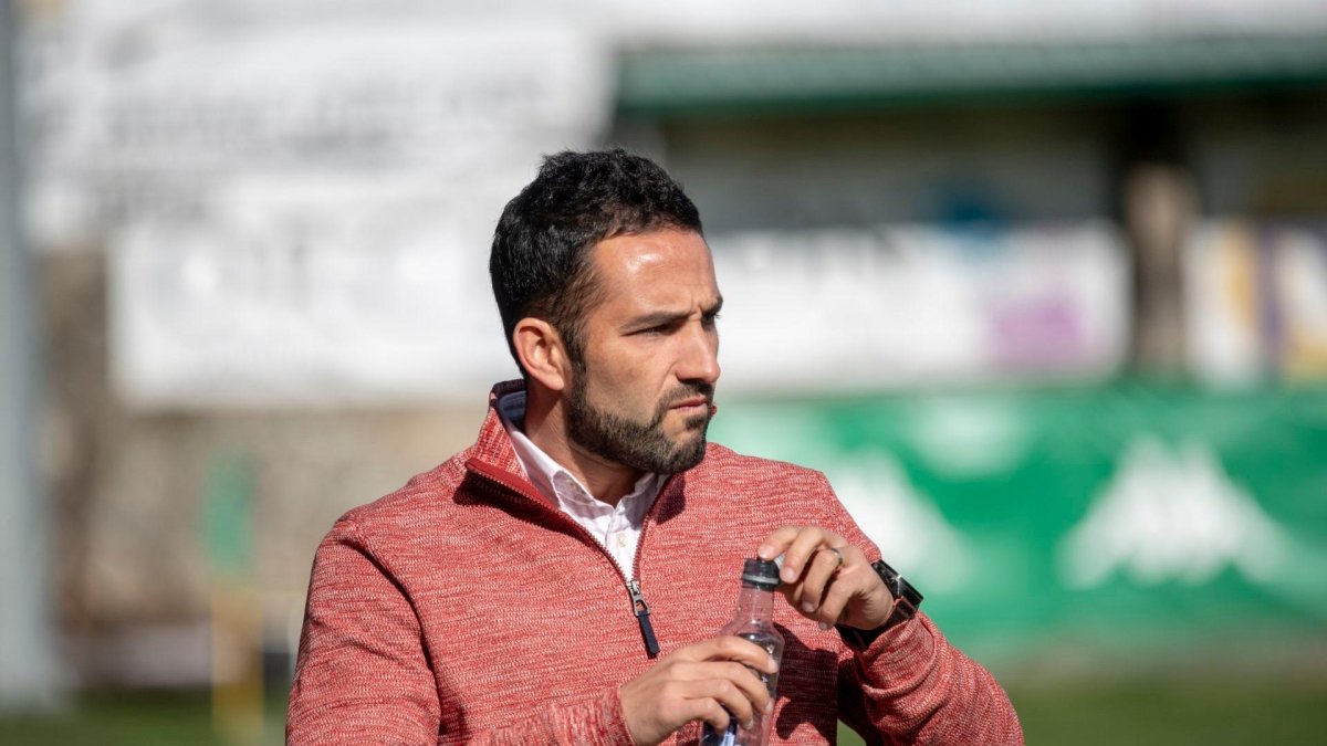 Dani Vidal bebe agua en el banquillo del Municipal de Espiñedo.