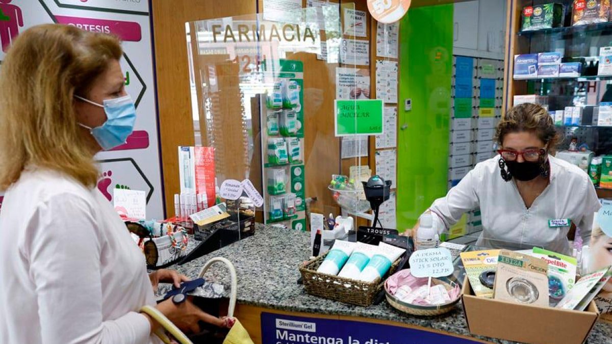 Una mujer y una dependienta de una farmacia de Madrid.