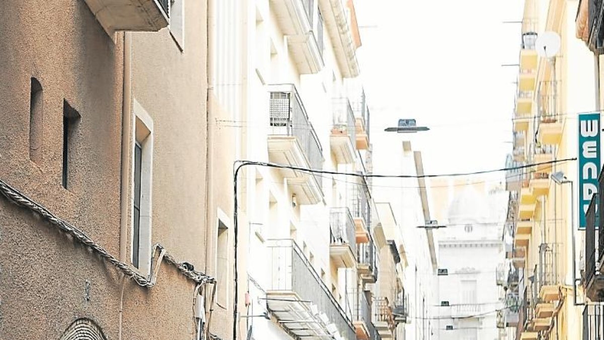 Los locales vacíos y el paso frecuente de coches son protagonistas en la calle.