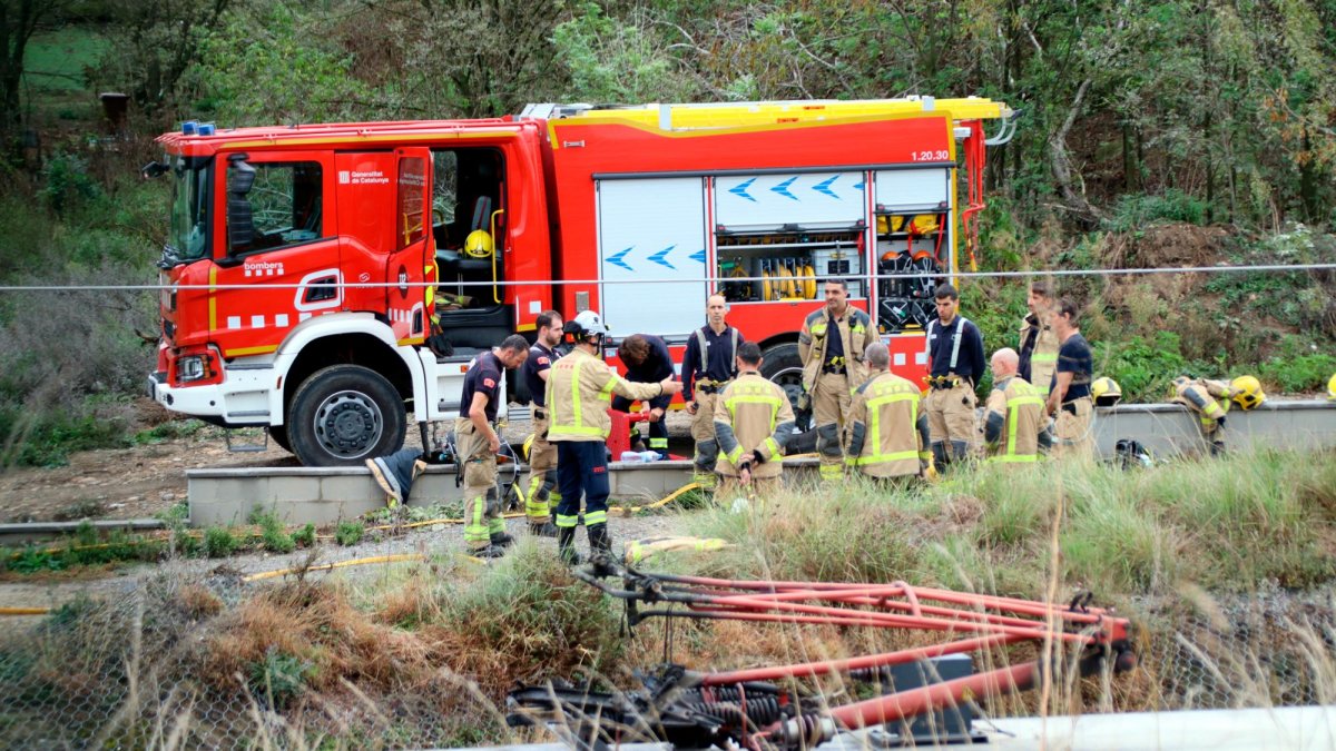 Vista del agujero que ha causado el incendio de la catenaria en el tramo de la R3. Al fondo, los bomberos.