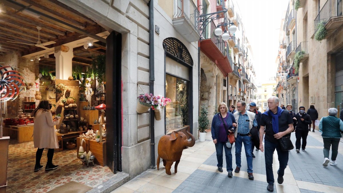 Turistas paseando y mirando tiendas en la Part Alta de Tarragona, ayer.