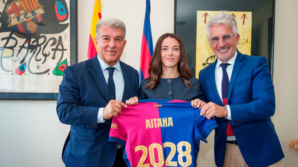 La jugadora del FC Barcelona, Aitana Bonmatí, junto con el presidente del club, Joan Laporta, y el directivo responsable del fútbol femenino, Xavier Puig, después de firmar su nuevo contrato hasta 2028.
