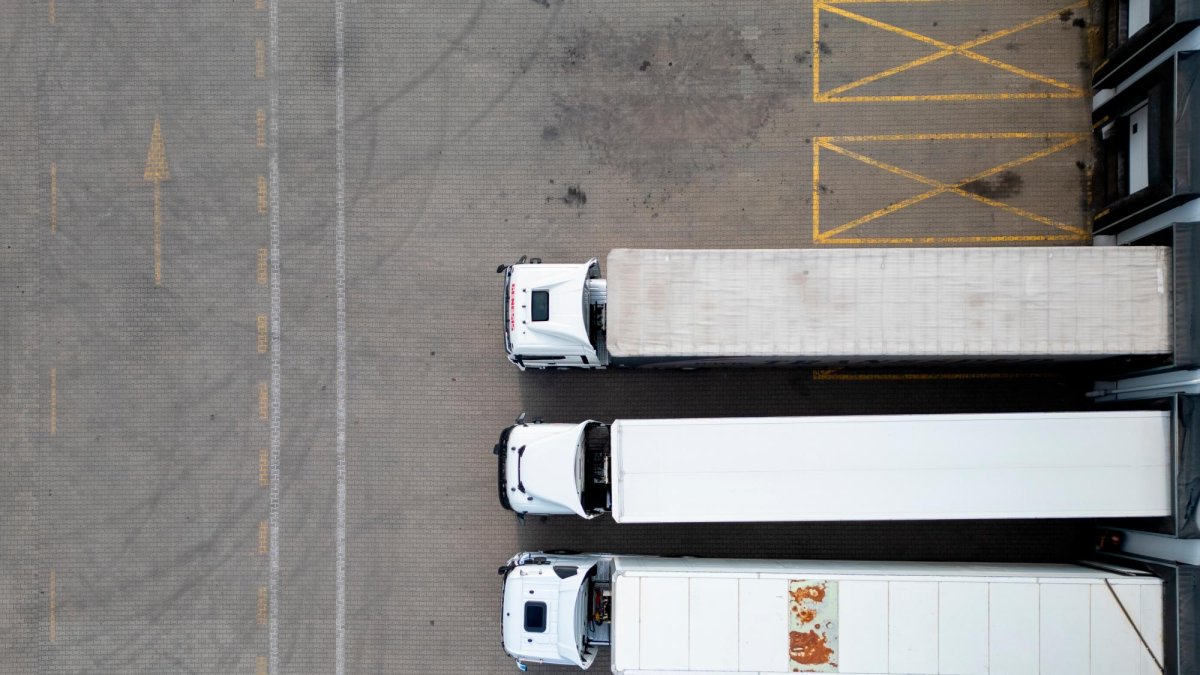 Tres camiones descargando en una empresa.