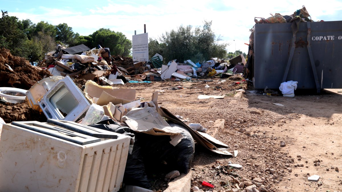 Deixalles i contenidors en un abocador provisional de residus dels aiguats a Alcanar