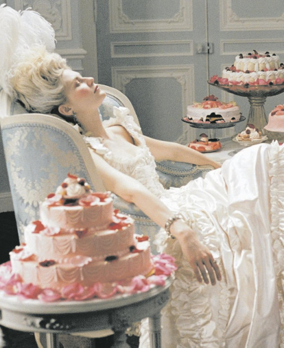 Kirsten Dunst como María Antonieta rodeada de pasteles en el filme de Sofía Coppola.